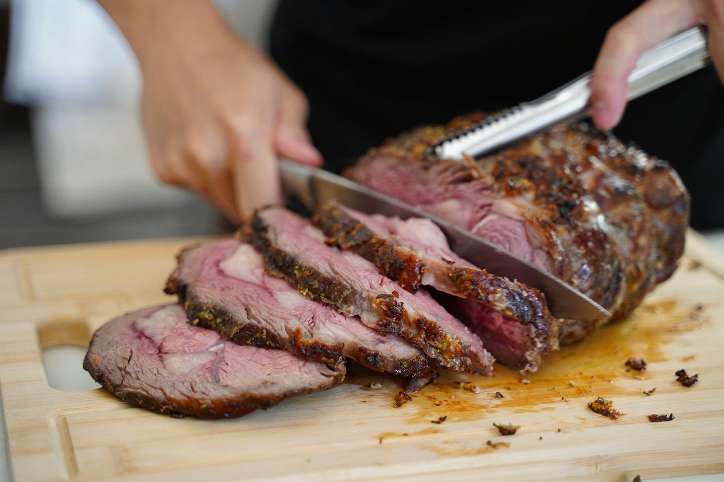Slow-roasted beef chuck roast with carrots and onions in a Dutch oven