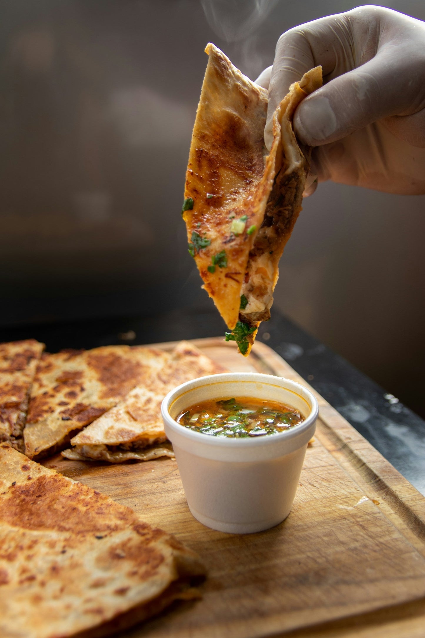 Crispy goat birria tacos with consommé for dipping
